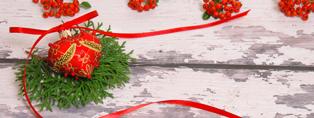 Christmas tree decoration with green branches on a background of light wooden boardsの写真素材
