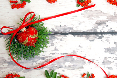 Christmas tree decoration with green branches on a background of light wooden boardsの写真素材