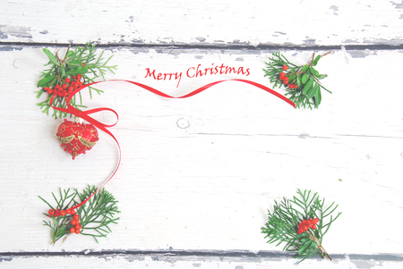 Christmas tree decoration with green branches on a background of light wooden boardsの写真素材