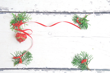 Christmas tree decoration with green branches on a background of light wooden boardsの写真素材
