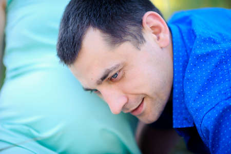 the husband has applied an ear to a tummy of the pregnant wife, warmth and care