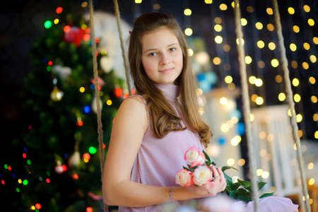 Waiting for Christmas. The girl waiting for a holiday has leaned the elbows for hours. New Year Peopleの写真素材