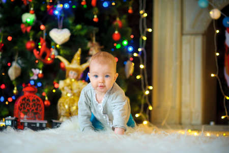 Waiting for Christmas. Happy children near a festive fir-tree waiting for holidays. New Year Peopleの写真素材