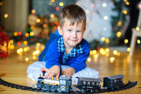 boy plays in New Year's studio, festive scenery, expectation of a holidayの写真素材