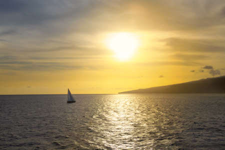 sailing yacht floats to the land at sunset, Mediterranean Seaの写真素材