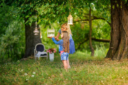 mother play with the beloved daughter in the beautiful park, smile and have fun, a happy familyの写真素材