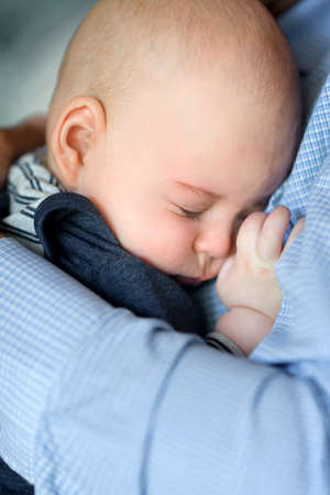 little newborn baby, sleeps at the father on handsの写真素材