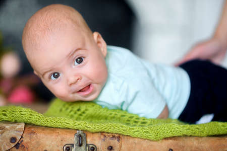beautiful kid with the big surprised eyes, with surprise looks in the cameraの写真素材