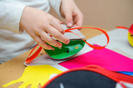 at a lesson of the fine arts, children do easter jewelry
