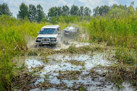 off-road competitions, two SUVs overcome a water obstacle, a set of splashes
