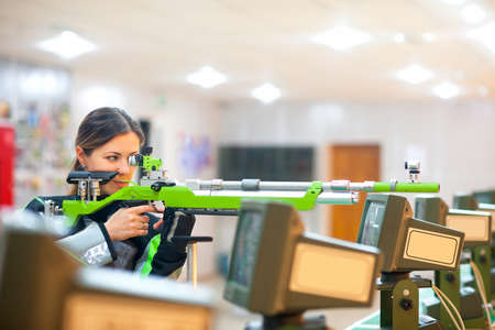 girl the athlete with a rifle, at sports firing competitionsの写真素材