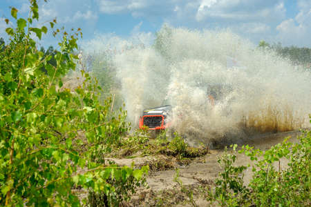 off-road competitions, the SUV are overcome by a water obstacle, a set of splashesのeditorial素材