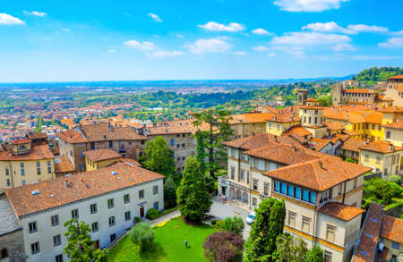 View from a roof on the small French town located in the foothills of the Alps in bright sunny day. A set of the lodges constructed in traditional styleの写真素材