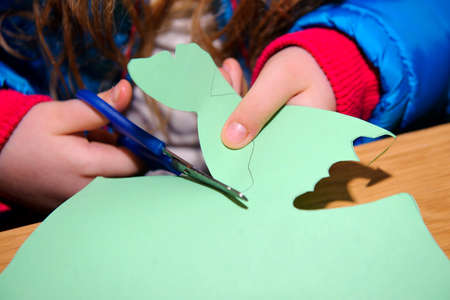 children at a lesson of the fine arts do hand-made articles of color paperの写真素材