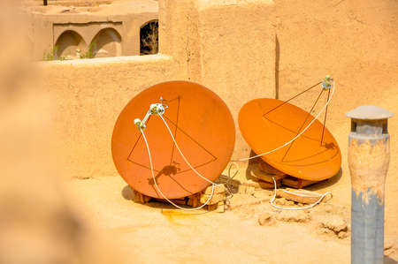 rusty satellite antennas on a roof of the Moroccan houses in old Medinaの写真素材