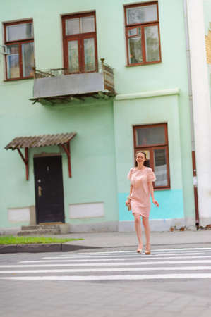 happy girl begiit on city streets, cheerfully laughsの写真素材