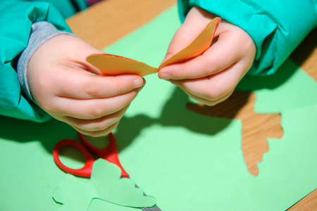 children at a lesson of the fine arts do hand-made articles of color paperの写真素材