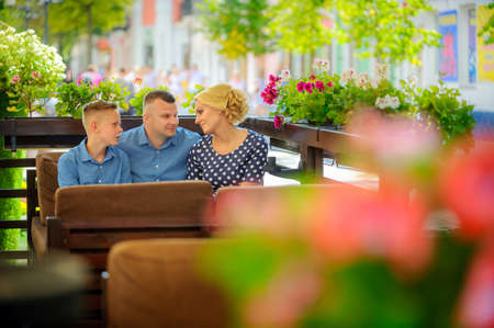 happy family in a cafe together hugging and smilingの写真素材