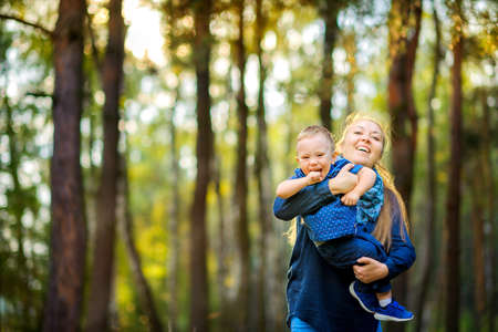 mother walks in the evening park with her beloved son