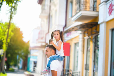 Dad walks around the city with his beloved daughterの写真素材