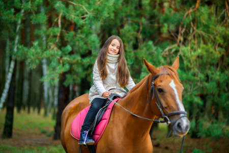a girl strolls on her horse, active restの写真素材