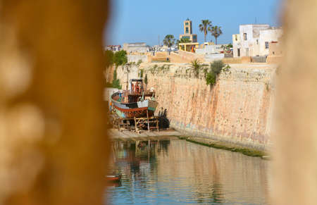 view through the fortress window on the fortress walls and the old ship