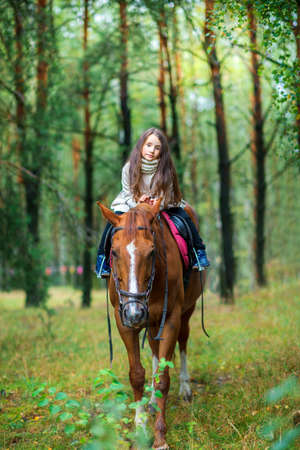 a girl strolls on her horse, active restの写真素材