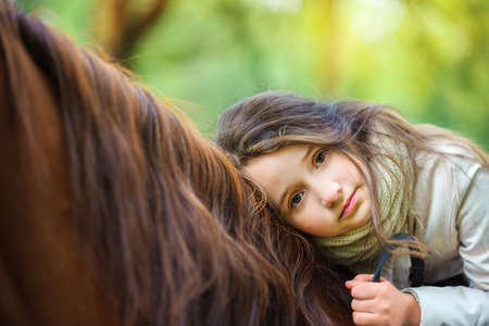 a girl strolls on her horse, active restの写真素材