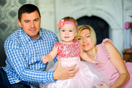 happy family in their home, Dad holds soy small board making first stepsの写真素材