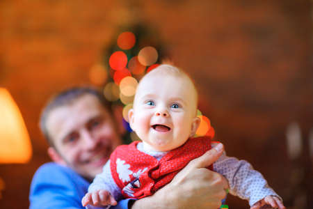 happy baby in dad's hands laughing and having funの写真素材
