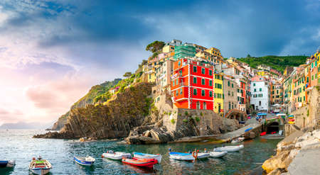 panorama of the famous Italian seaside viilage Riomaggiore at sunset, Cinque Terre. Italyの写真素材