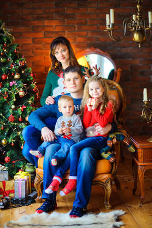 happy family sitting in a chair and embracingの写真素材
