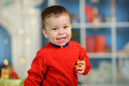 cheerful kid runs and plays in the room, children's fun