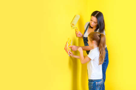 mom and daughter choose a color for painting walls in copate, repairs in the room