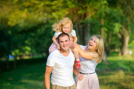 happy family in the evening park, walking and having funの写真素材