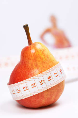 Overweight check-up (Red pear, blur woman on background)の写真素材