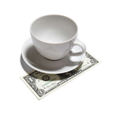 One dollar tip - closeup of one dollar, tea cup and saucer isolated on white backgroundの写真素材