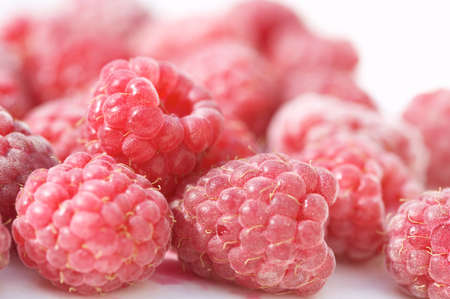 Closeup of raspberries on white background. Shallow focus depth on front berries