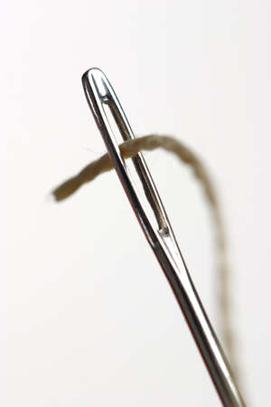 To run a thread through an eyelet; Needle with thread on white backgroundの写真素材