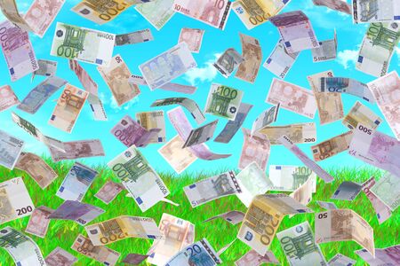 money falling with the background grass and skyの写真素材