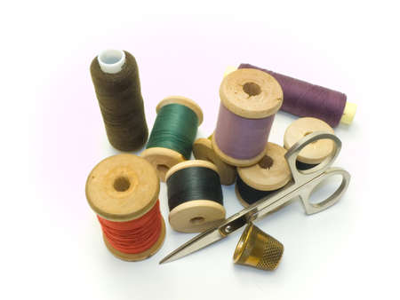An isolated colourful photo of several threads and scissors