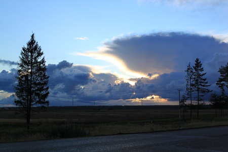 Sunset hidden in dark blue cloudsの写真素材