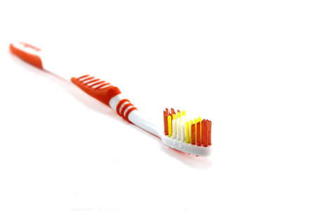Close up of a orange toothbrush over white backgroundの写真素材