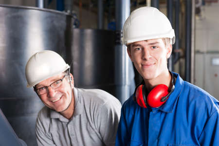 happy engineers with safety helmet, earplug and glasses