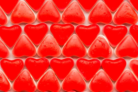 Valentine background with red hearts of candy