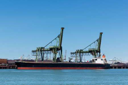 Large vessel unloading its iron ore cargoの写真素材