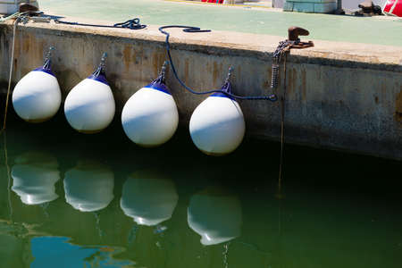 fenders to moor ships in a harborの写真素材
