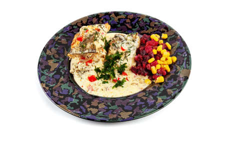 ready-to-eat fish dish with cream sauce and vegetables, isolated in a dark bowl