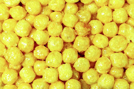 Sweet cornballs covered with syrup, top view