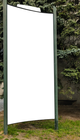 Empty vertical advertising stand by a pine tree in daylightの写真素材